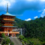 Ancient temple ruins in Asia surrounded by trees at sunrise