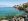 Scenic view of Lake Garda with mountains and a quiet lakeside village at sunset