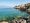 Scenic view of Lake Garda with mountains and a quiet lakeside village at sunset