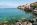 Scenic view of Lake Garda with mountains and a quiet lakeside village at sunset